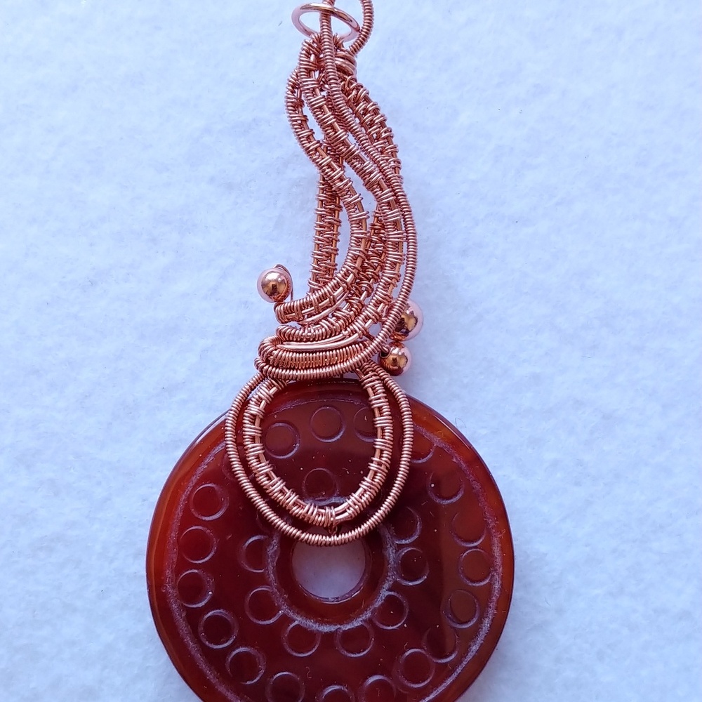 Copper wire weave with carnelian doughnut